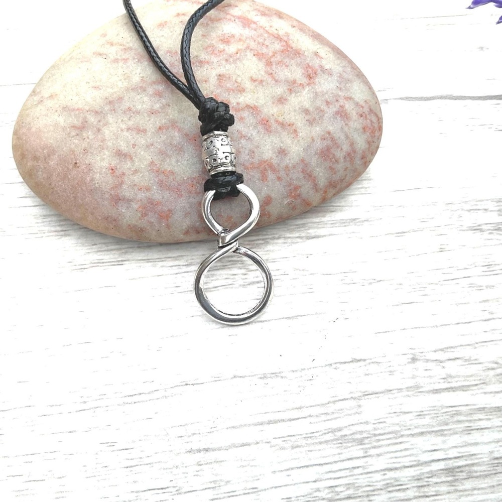 Minimalist silver infinity loop eyeglass holder on adjustable black cord